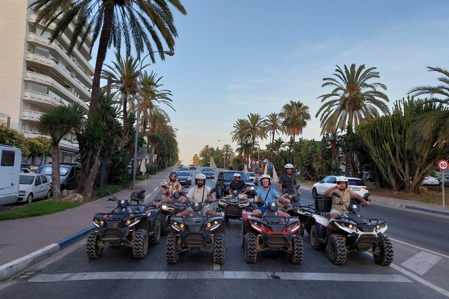 Quad convoy on a palm-lined avenue in Marbella